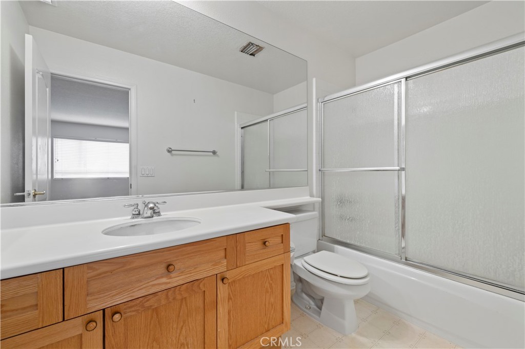 25018 Smokewood Way Stevenson Ranch, CA 91381 - Photo 50 of 71 a bathroom with a sink toilet vanity and shower