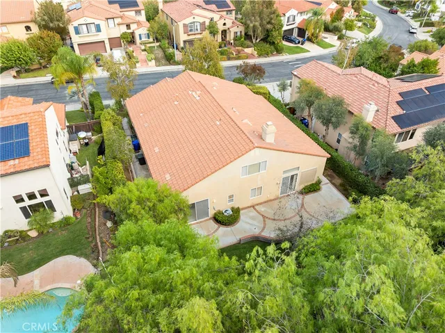 a view of a brick house with a large windows and a large tree