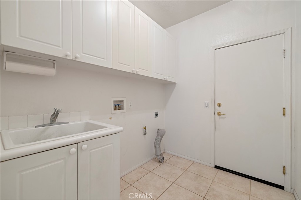25018 Smokewood Way Stevenson Ranch, CA 91381 - Photo 52 of 71 a kitchen with a sink and cabinets