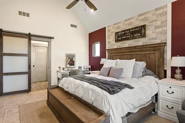 a bedroom with a bed and a large window