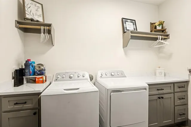 a bathroom with a double vanity sink mirror and shower