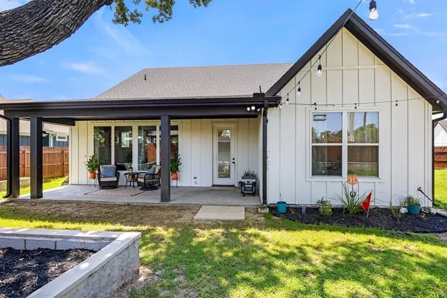 a front view of a house with swimming pool and porch