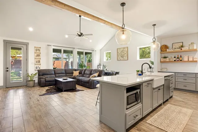 a living room with furniture and a chandelier