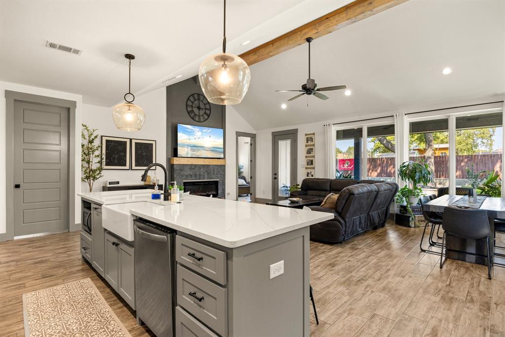 2000 Rattler Way Tolar, TX 76476 - Photo 32 of 33 a large white kitchen with a stove a sink dishwasher a dining table and chairs with the living room