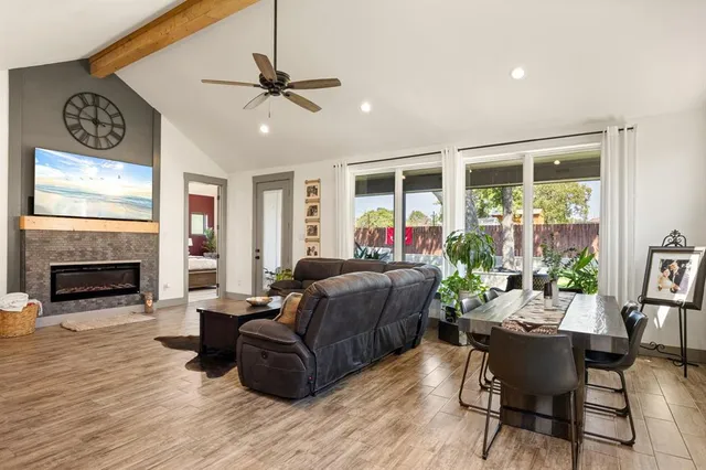 a kitchen with stainless steel appliances granite countertop a sink a stove a refrigerator and island with wooden floor