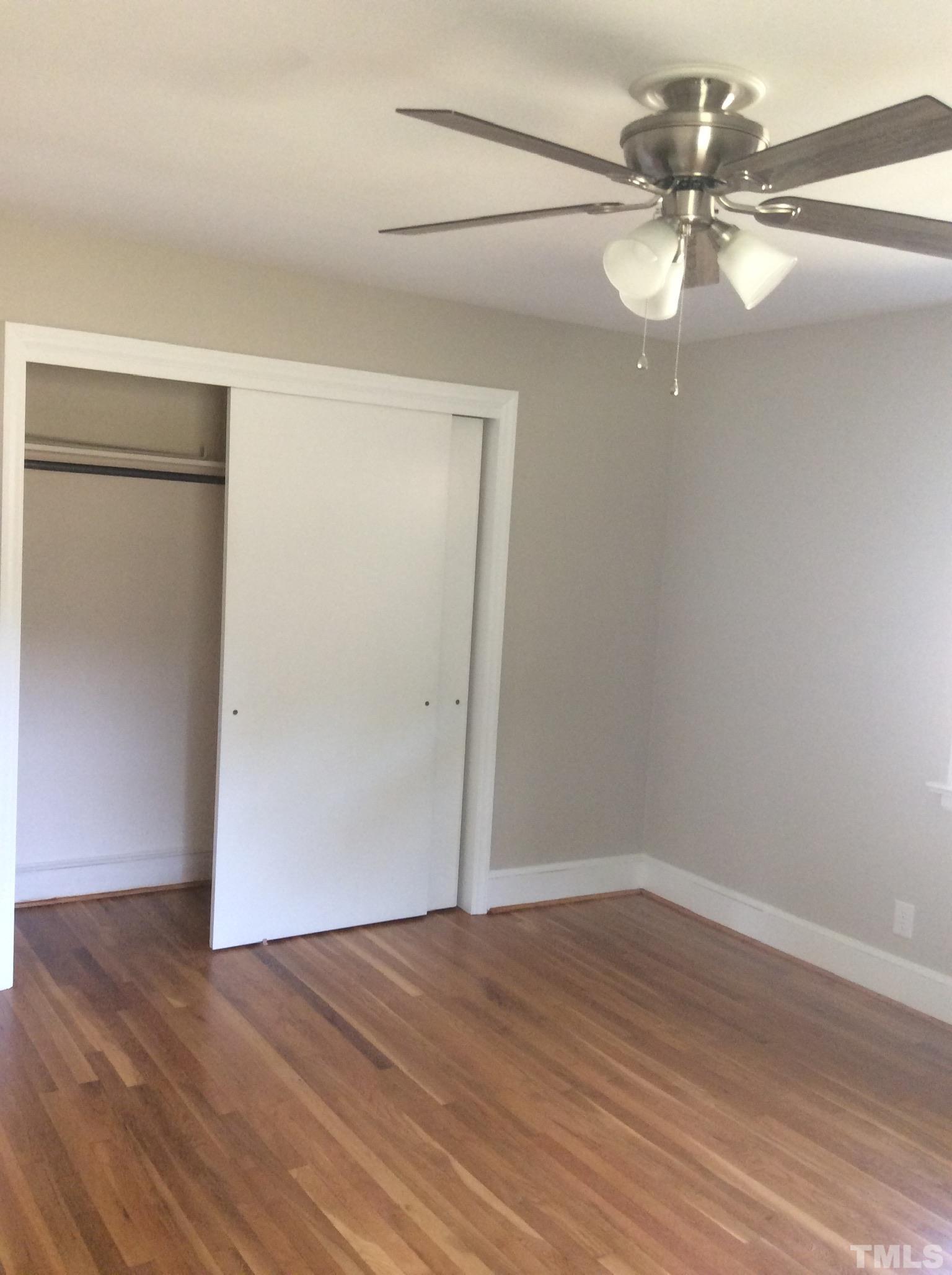 3424 Moriah Road Rougemont, NC 27572 - Photo 15 of 20 an empty room with wooden floor fan and windows