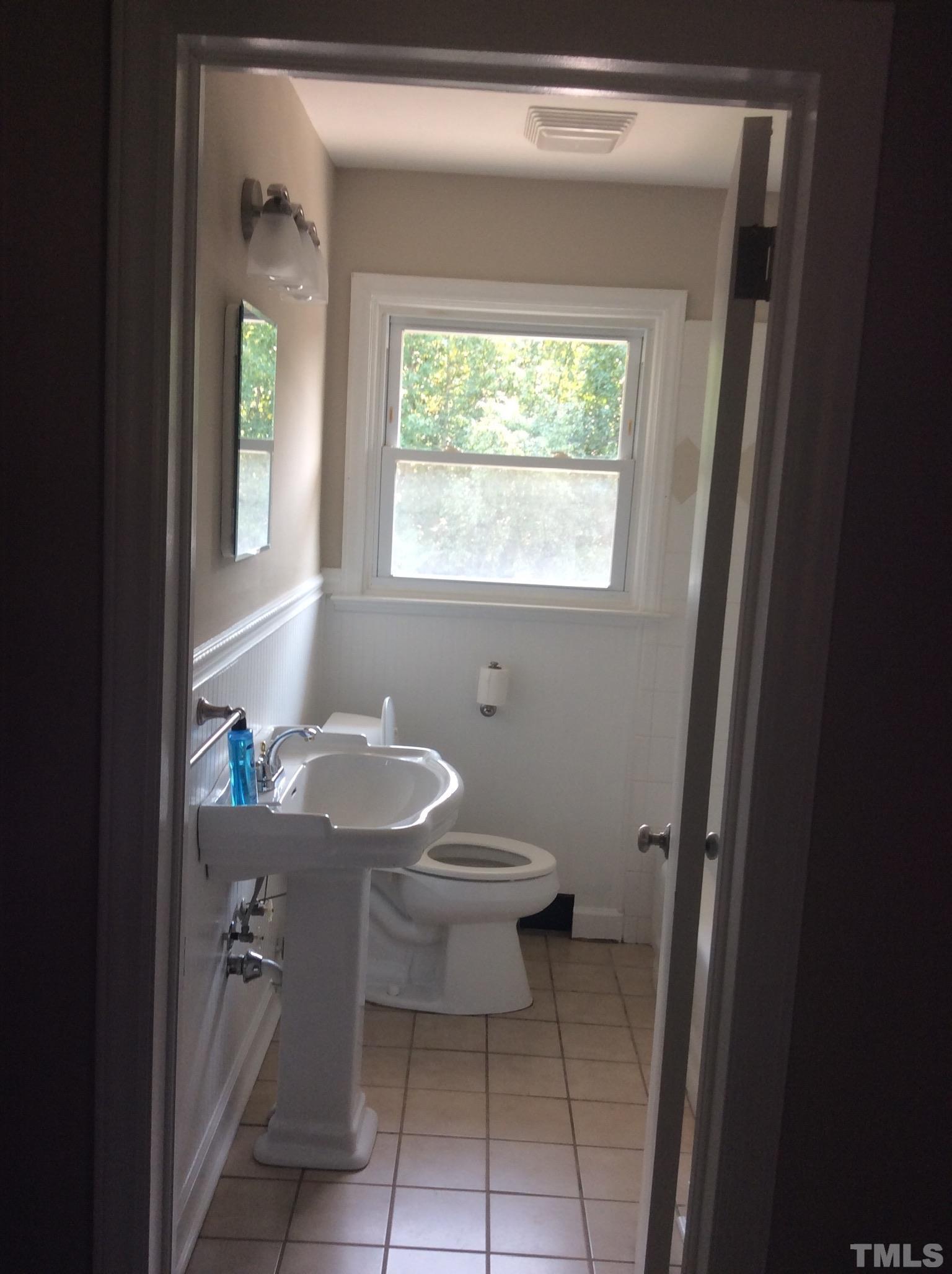 3424 Moriah Road Rougemont, NC 27572 - Photo 18 of 20 a bathroom with a toilet a sink and a window