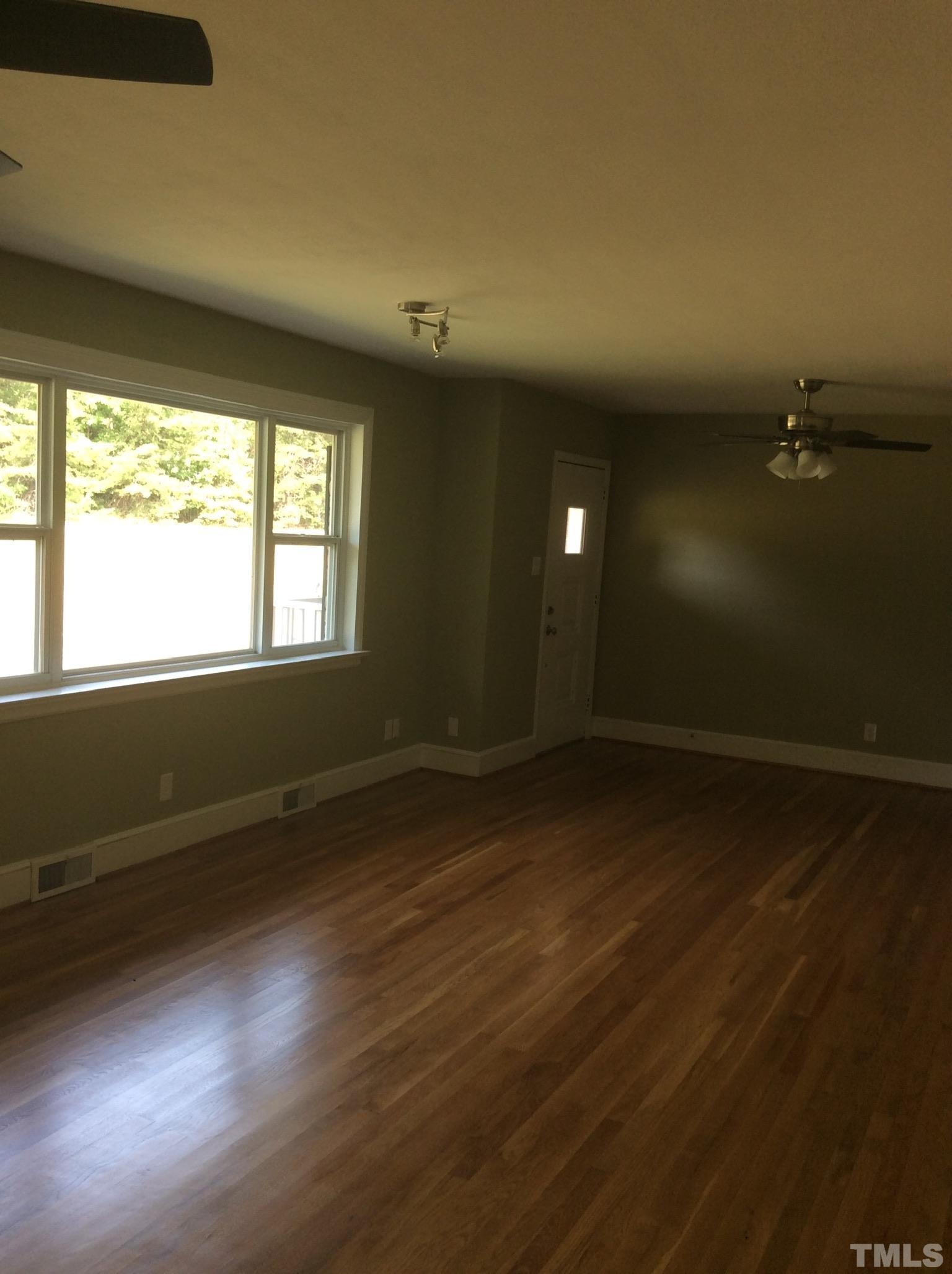 3424 Moriah Road Rougemont, NC 27572 - Photo 9 of 20 an empty room with wooden floor and windows