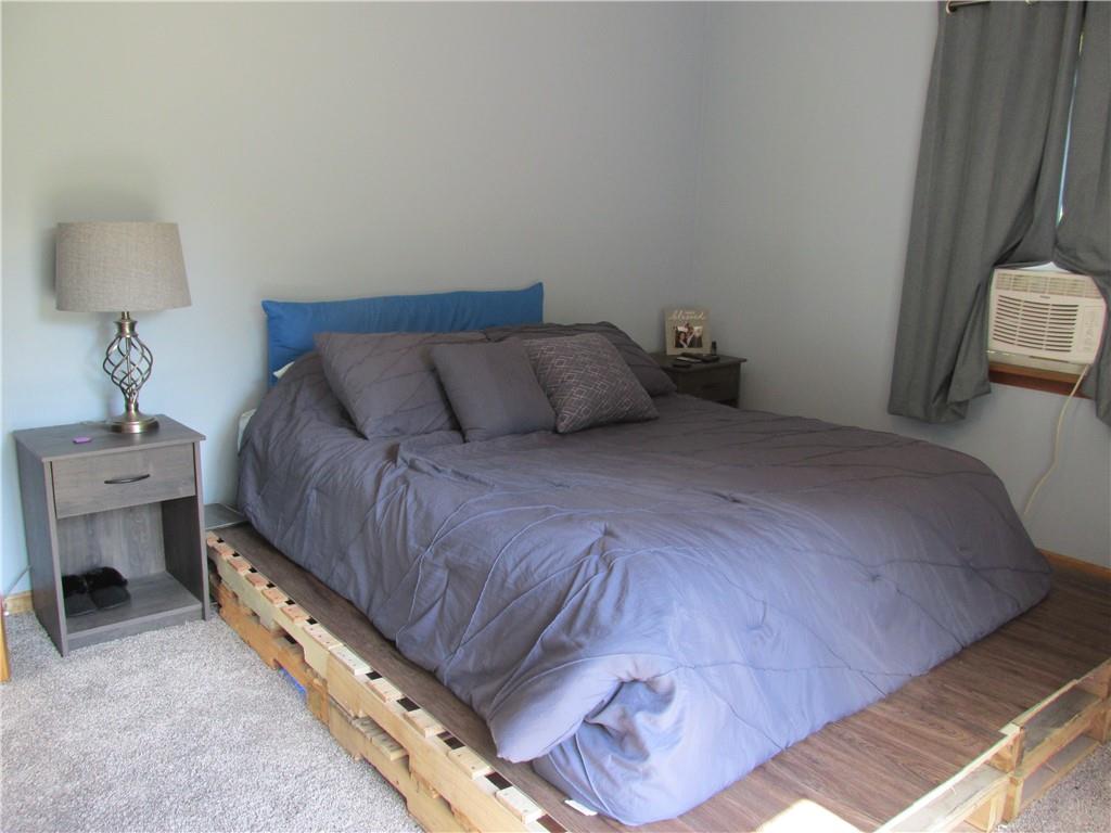 421 Mercer Road Greenville, PA 16125 - Photo 18 of 25 a bedroom with a bed and a chair