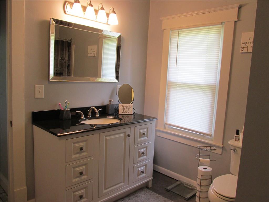 421 Mercer Road Greenville, PA 16125 - Photo 21 of 25 a bathroom with a granite countertop toilet sink and mirror