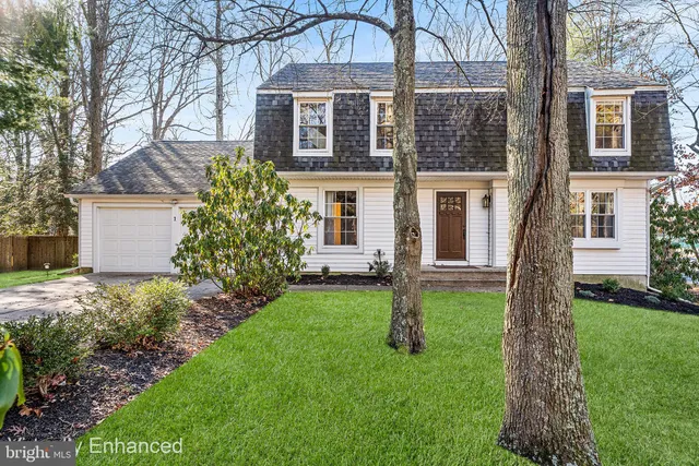 a front view of a house with a garden and yard