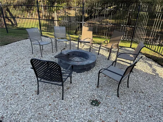 a view of a chairs and table in backyard