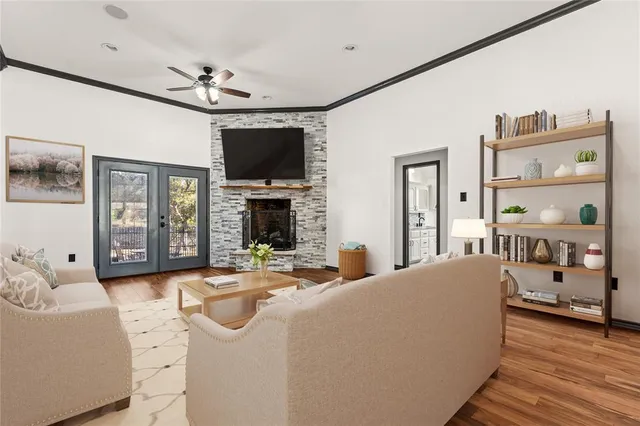 a living room with furniture a flat screen tv and a fireplace