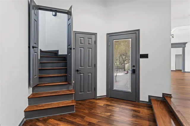 a view of front door with wooden floor and stairs