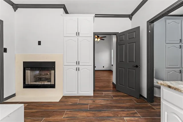 a view of a hallway with wooden floor and staircase