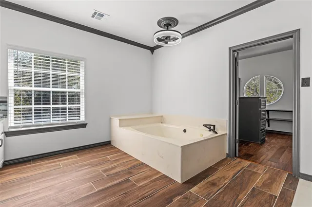 a view of a room with a window and wooden floor