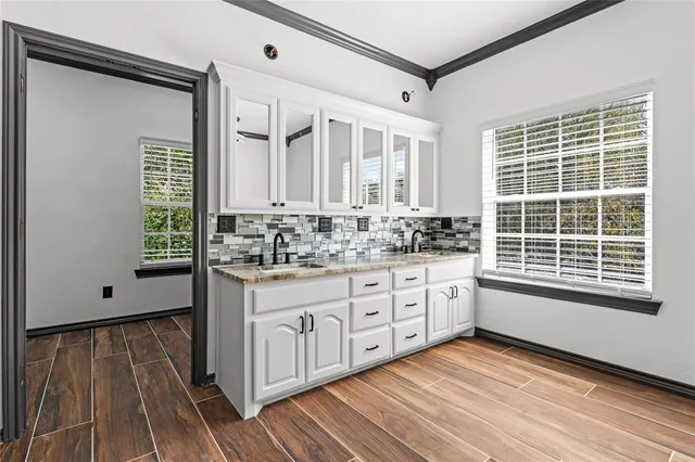 a bathroom with a sink mirror and a window