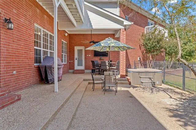 a view of a patio with a table and chairs under an umbrella