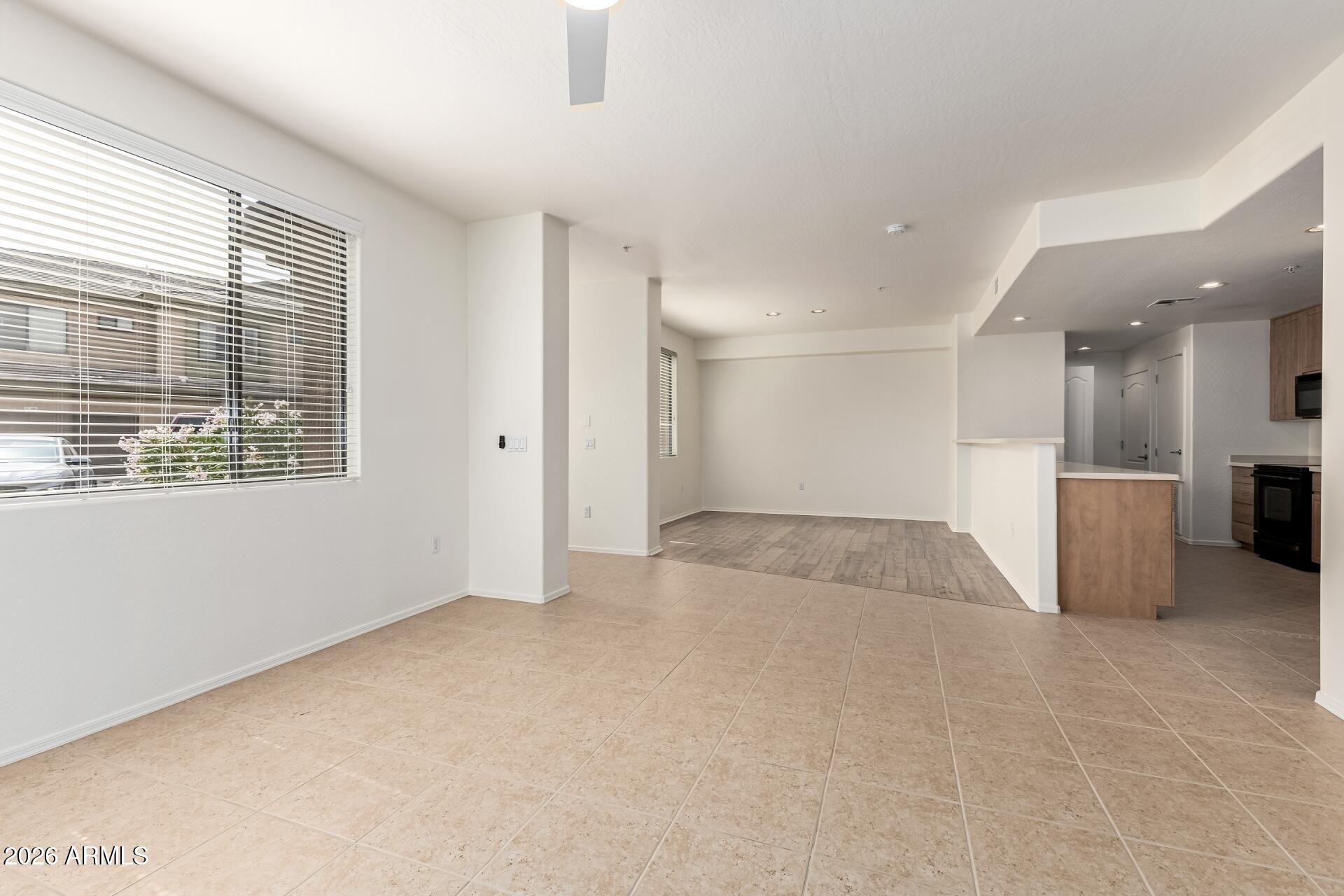 705 West Queen Creek Road, Unit 1167 Chandler, AZ 85248 - Photo 9 of 31 a view of an empty room with a kitchen