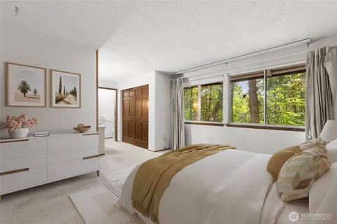 a spacious bedroom with a bed and a large window
