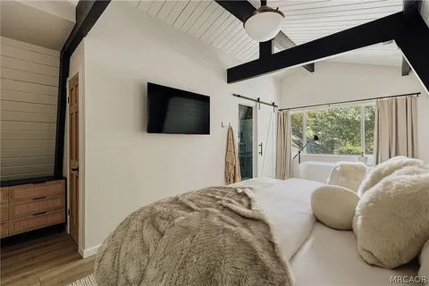 a bedroom with a bed and a mirror