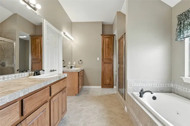 a bathroom with a tub and shower