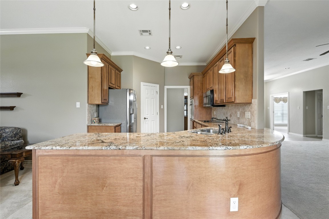 100 Davis Court Thorndale, TX 76577 - Photo 25 of 39 a view of a kitchen with kitchen island a sink appliances and a counter top space