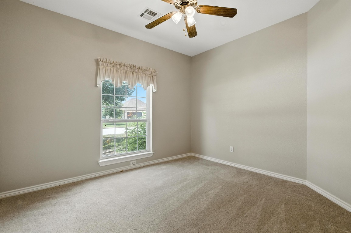 100 Davis Court Thorndale, TX 76577 - Photo 28 of 39 an empty room with windows and chandelier fan