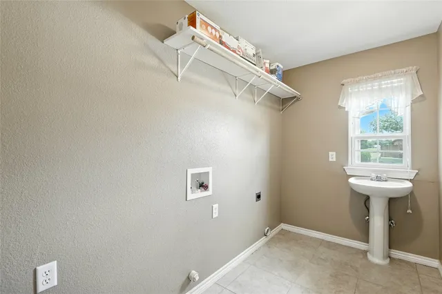 a backyard of a house with table and chairs