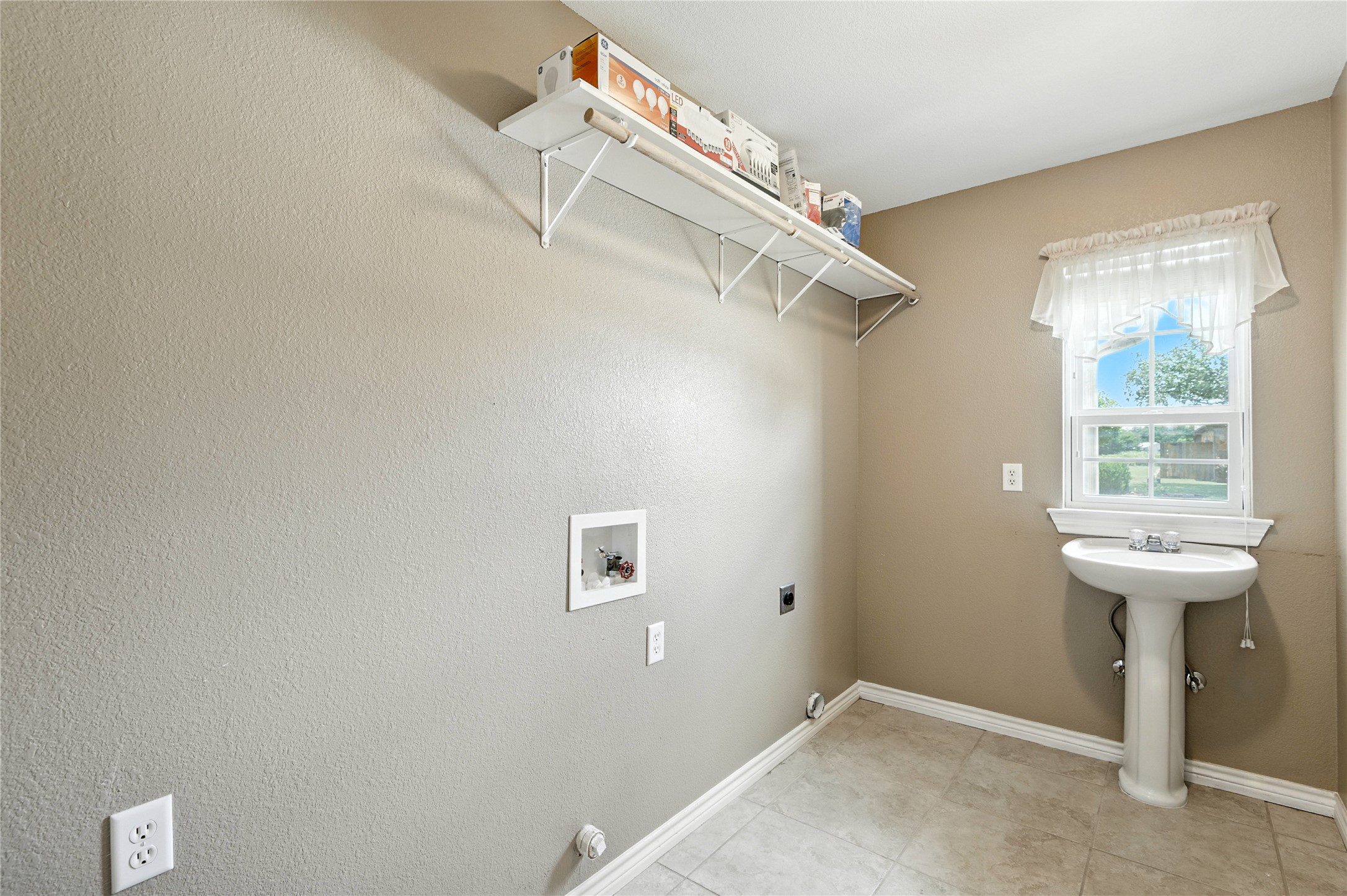 100 Davis Court Thorndale, TX 76577 - Photo 33 of 39 Laundry area featuring electric dryer, washer hookup and extra handy sink makes it a mudroom too!