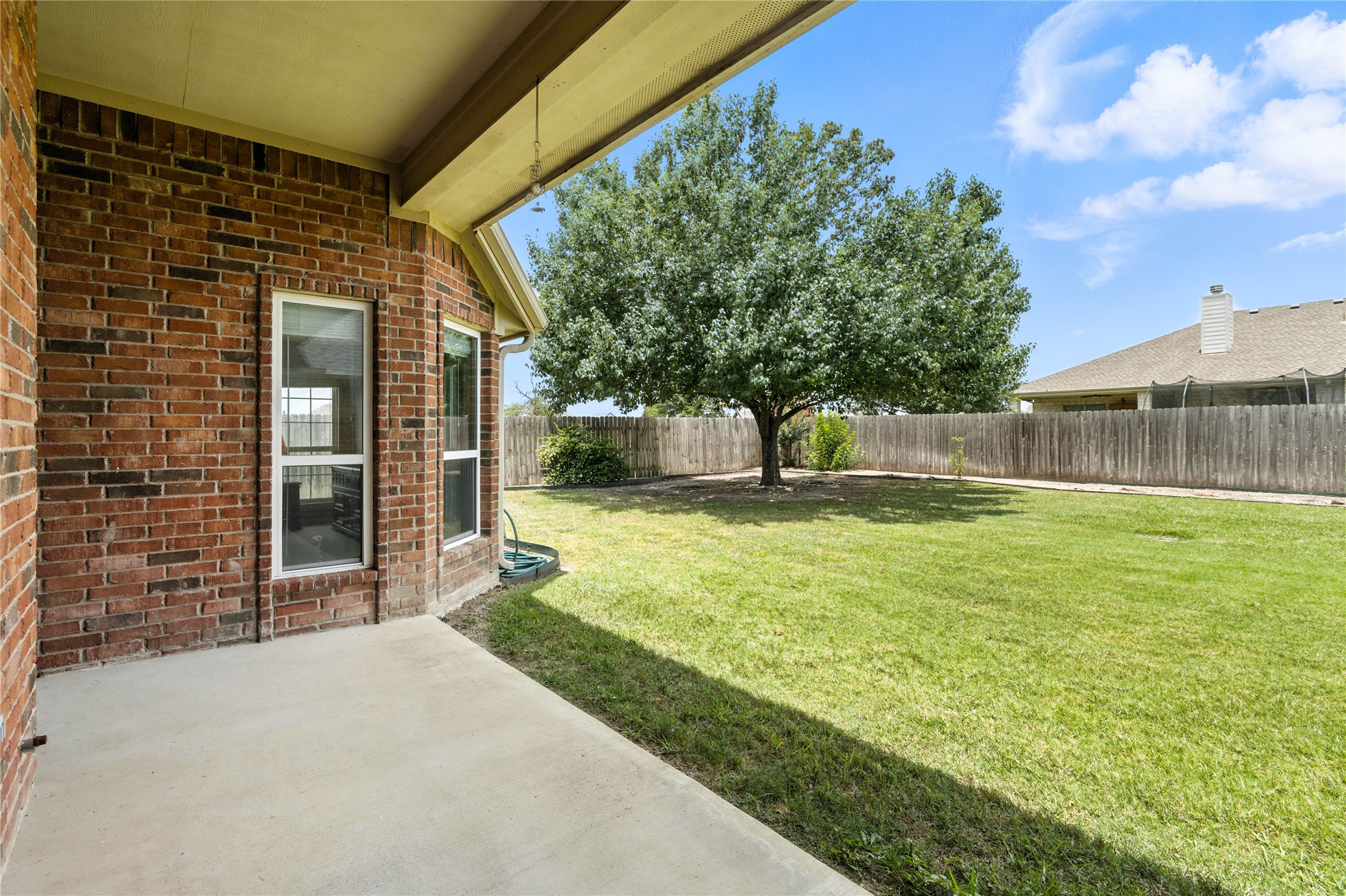 100 Davis Court Thorndale, TX 76577 - Photo 34 of 39 Privacy fenced backyard with a covered patio. Just add TV and BBQ pit