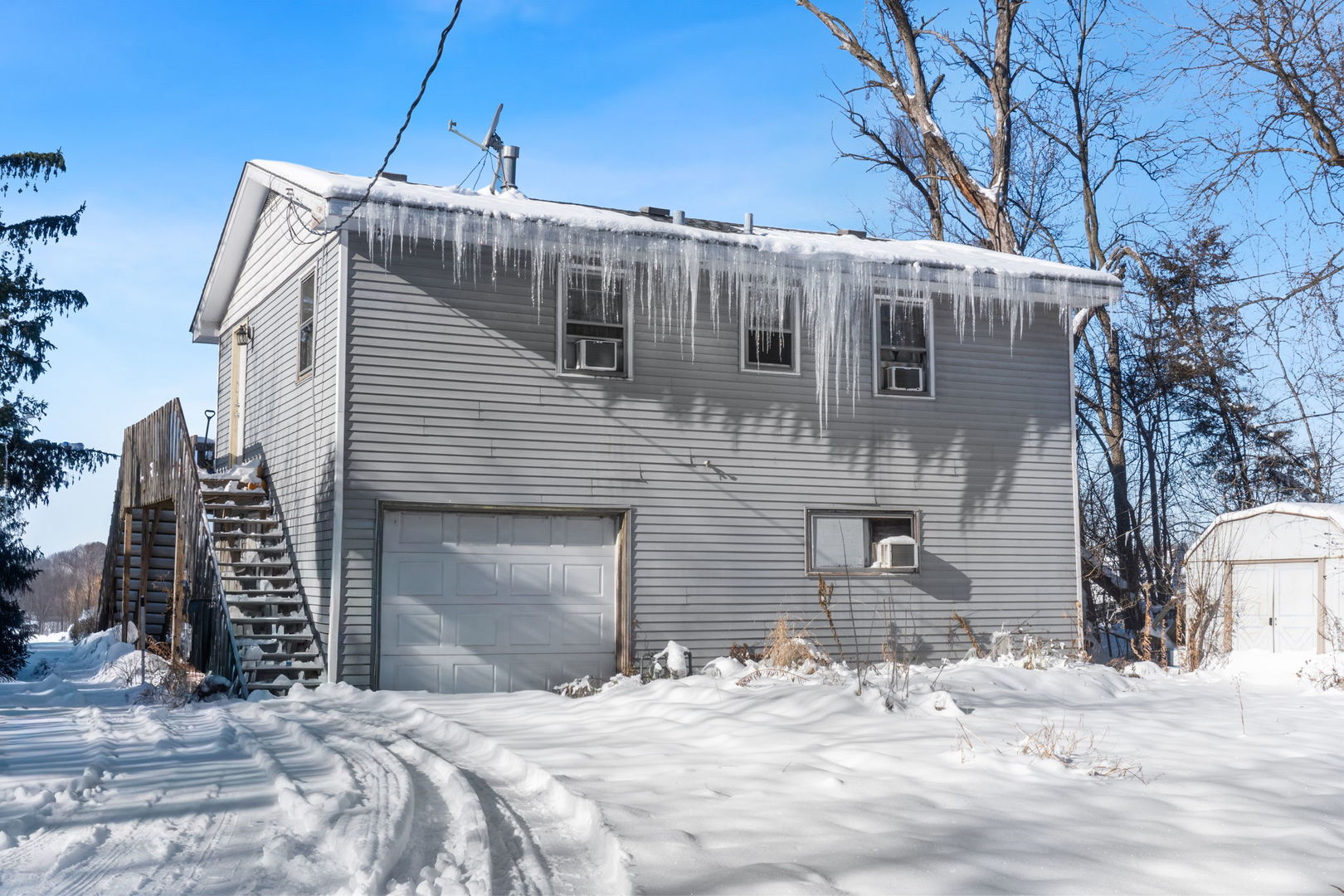 a view of a house with snow on the road