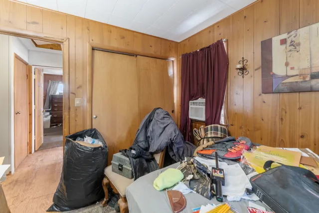 a bedroom with a bed and a mirror