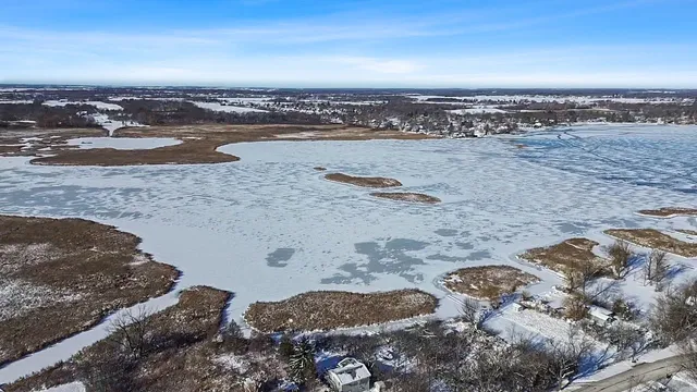 a living room with furniture and large windows