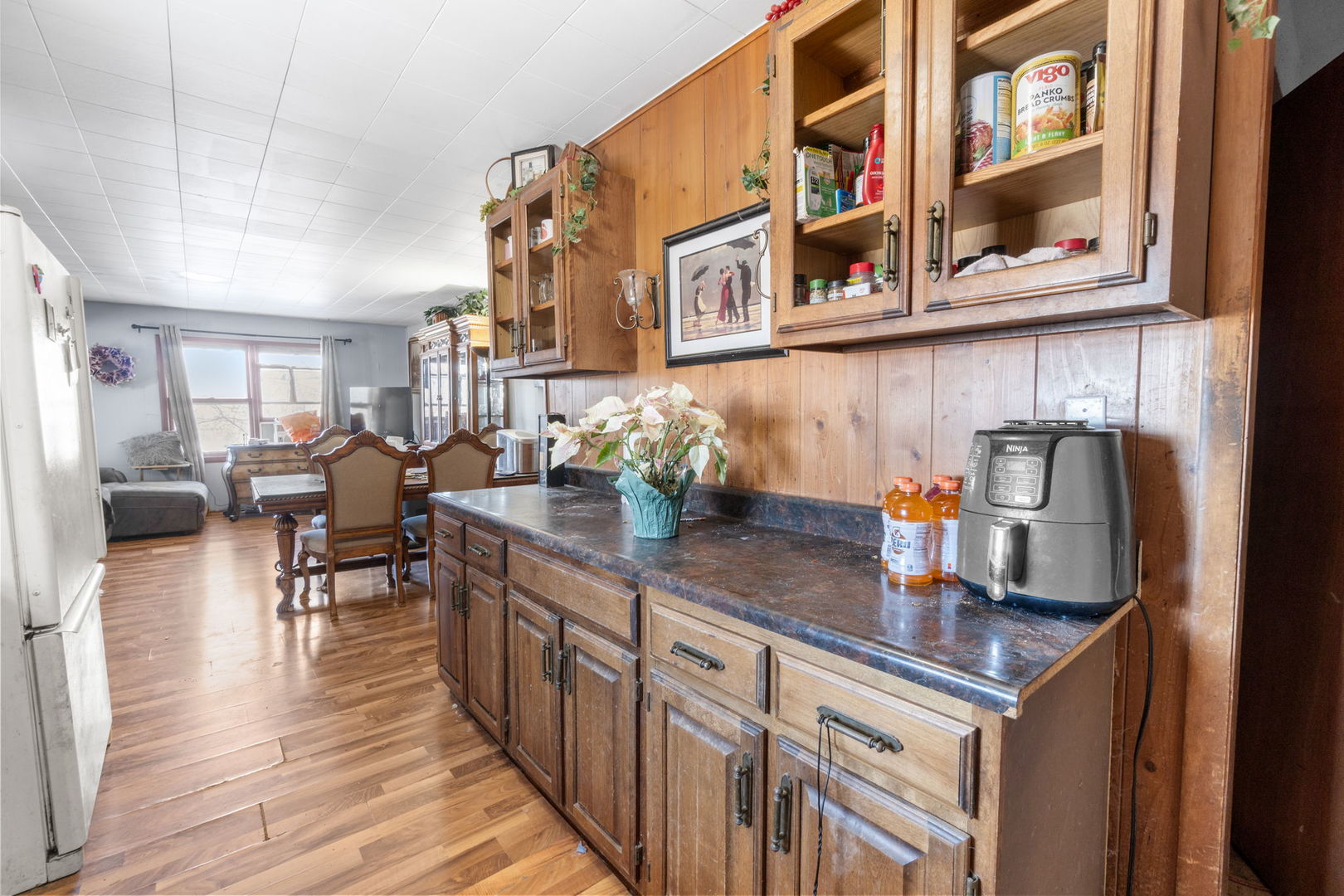 11505 Lakeview Road Richmond, IL 60071 - Photo 10 of 22 a kitchen with stainless steel appliances granite countertop a table chairs in it and wooden floors
