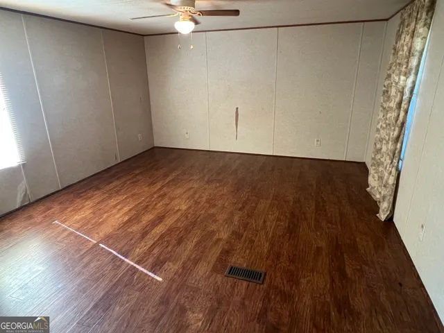 a view of a room with wooden floor