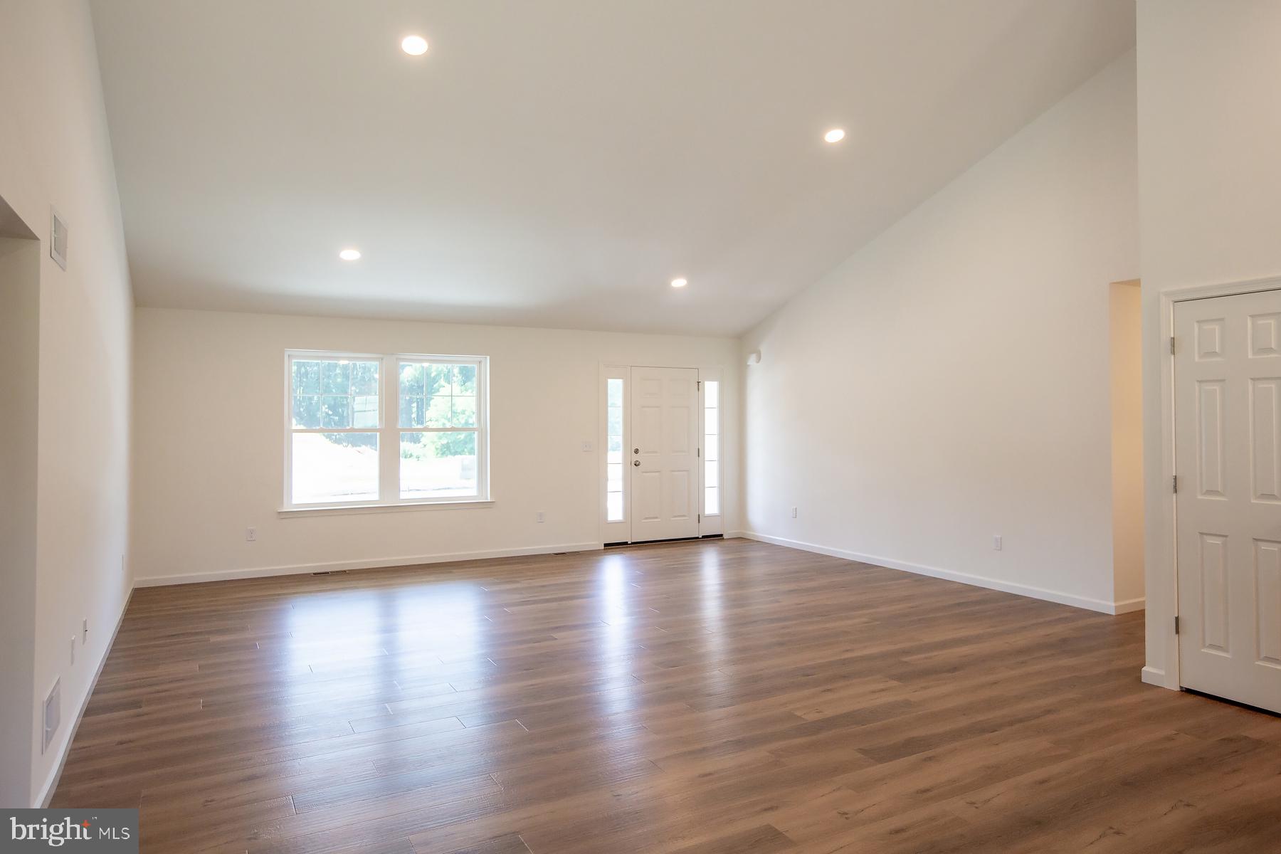 Spacious, sunlit living area awaits you.