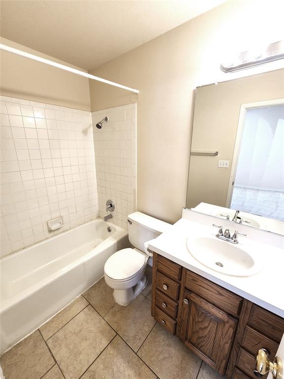 8811 Clearbrook Trail Austin, TX 78729 - Photo 12 of 38 lft A - A classic tiled tub and shower combination with a single vanity and mirrored wall offers functional comfort.
