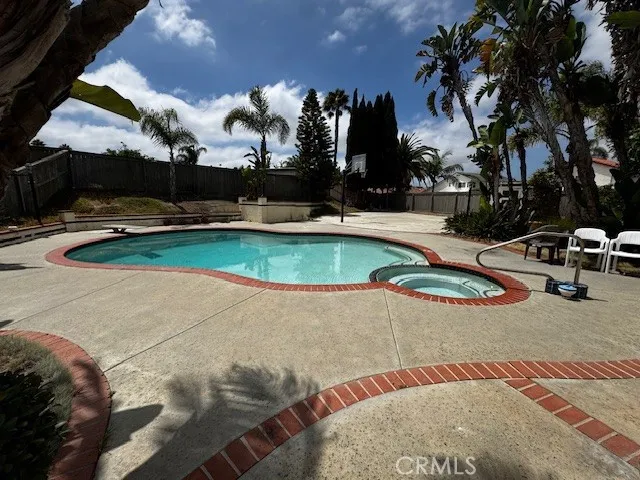 a view of a swimming pool with an outdoor space and seating area