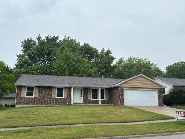 a front view of a house with a garden and trees