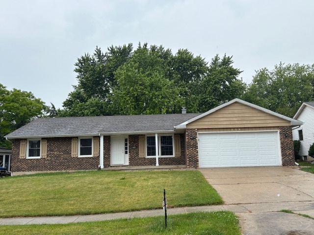 654 Longview Drive Antioch, IL 60002 - Photo 2 of 22 a front view of a house with a garden