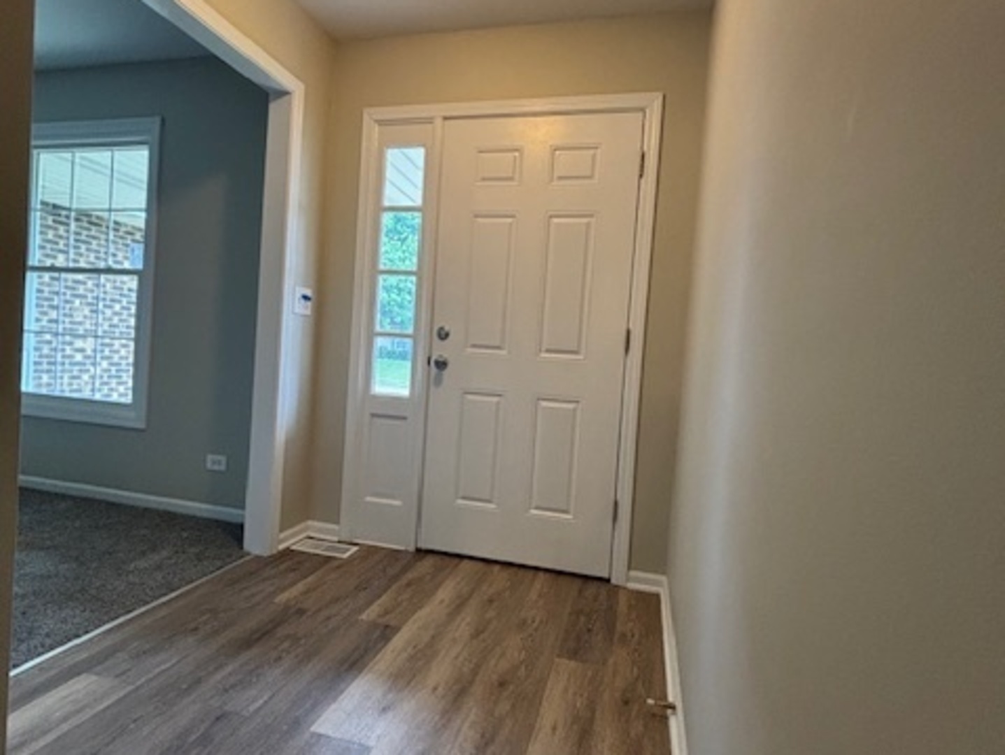 654 Longview Drive Antioch, IL 60002 - Photo 5 of 22 an empty room with wooden floor closet and windows