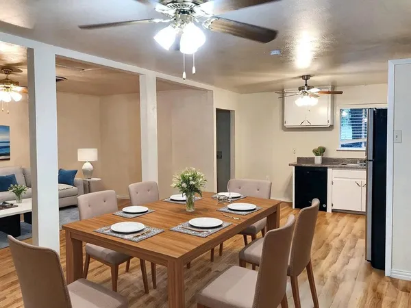 a view of a dining room with furniture and wooden floor