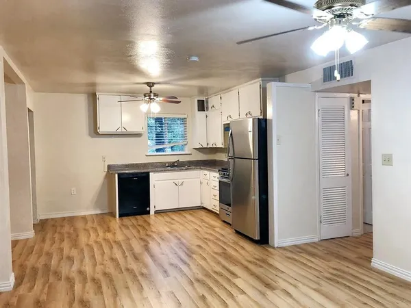 a kitchen with stainless steel appliances granite countertop a refrigerator and a sink