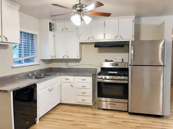 a kitchen with stainless steel appliances granite countertop a stove and a refrigerator