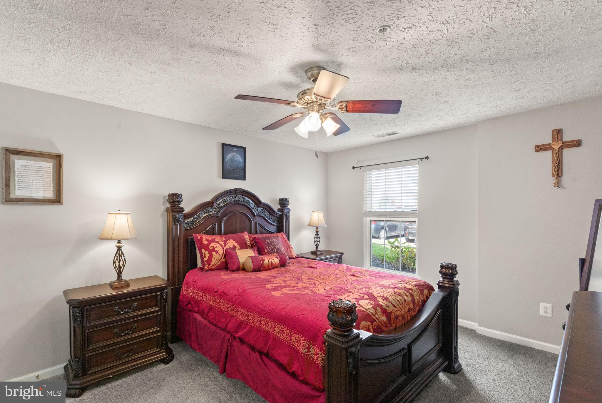 16 Brook Farm Court, Unit 16D Perry Hall, MD 21128 - Photo 11 of 23 a bedroom with a bed and a chandelier