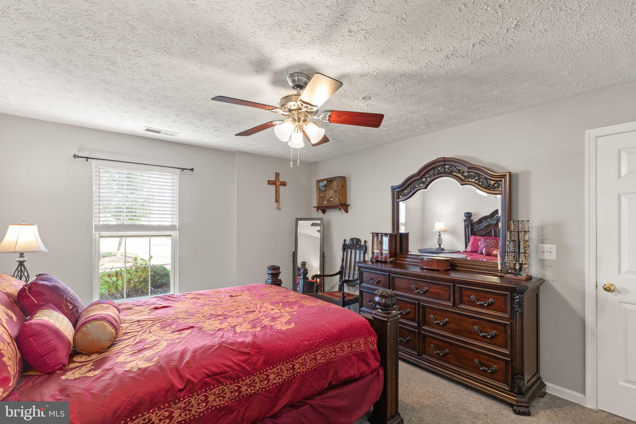 16 Brook Farm Court, Unit 16D Perry Hall, MD 21128 - Photo 12 of 23 a bedroom with a bed and a chandelier