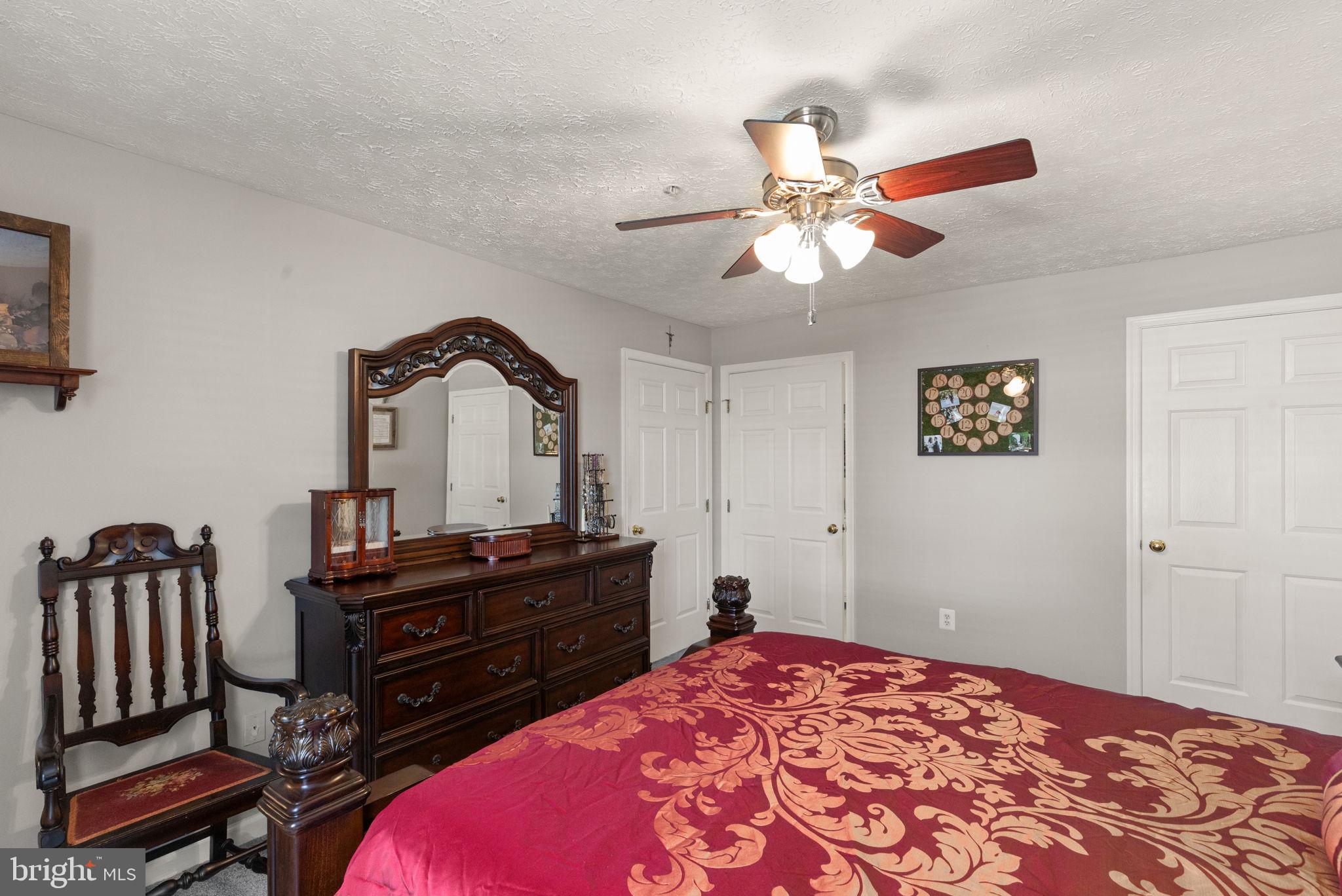 16 Brook Farm Court, Unit 16D Perry Hall, MD 21128 - Photo 13 of 23 a bedroom with a bed and a chandelier
