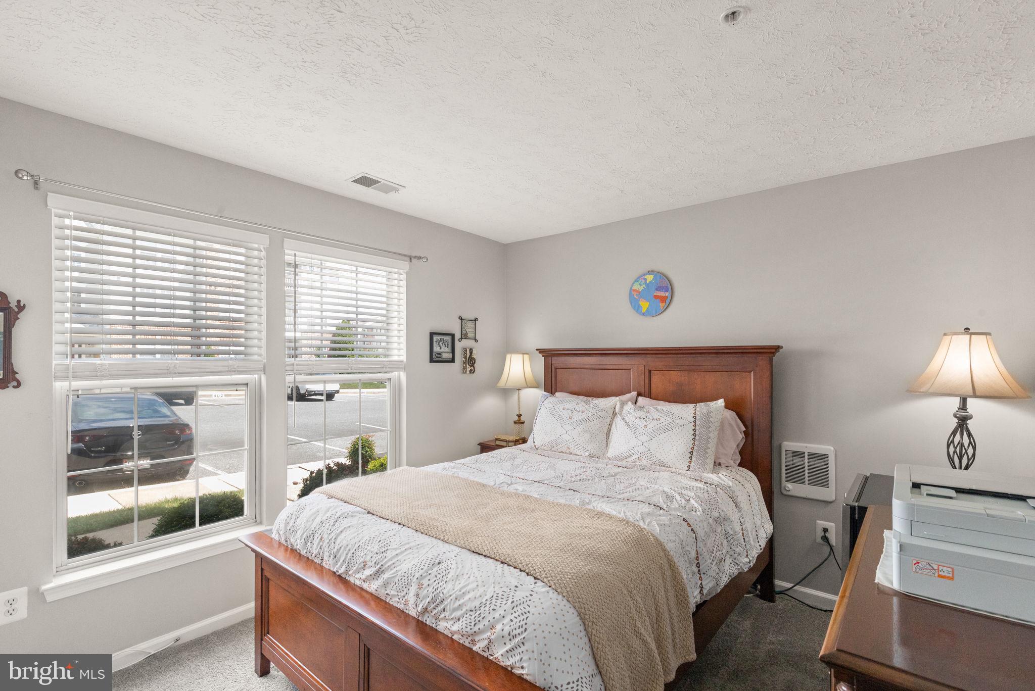 16 Brook Farm Court, Unit 16D Perry Hall, MD 21128 - Photo 16 of 23 a bedroom with a large bed and a large window