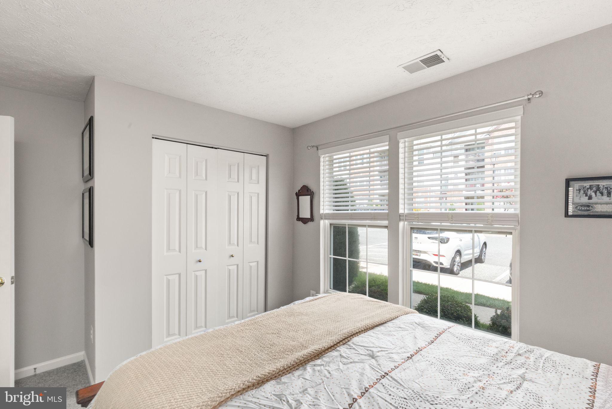 16 Brook Farm Court, Unit 16D Perry Hall, MD 21128 - Photo 17 of 23 a bedroom with a bed and a large window with outer view